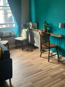 a living room with a desk and a chair at Bells Yard cottage in Maryport