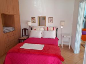 a bedroom with a bed with a red blanket at Elea Guesthouse in Galaxidi