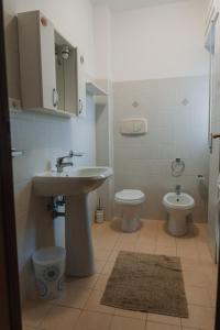 a bathroom with a sink and a toilet at Casa vacanze La Farfalla in San Vito Chietino