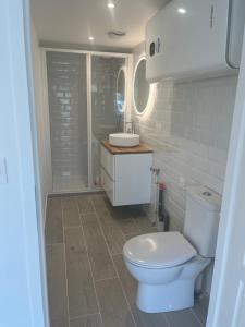 Mini maison - Oncy détend في Oncy: حمام به مرحاض أبيض ومغسلة