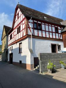 a white and red building with a flag on it at Fachwerk-Romantik 2 an der Mosel in Treis-Karden