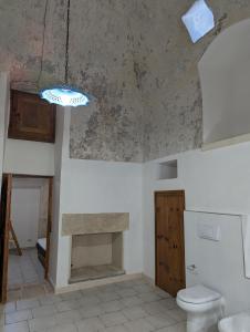 a bathroom with a sink and a toilet at Masseria Petrore Grande di Polimeno Alessandra in Cutrofiano