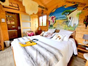 una camera da letto con un letto su cui è sdraiato un cane di Chambre d'hôtes & SPA Mas Dels Esquirols a Saint-André Altre 38 foto