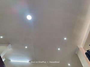 a room with a white ceiling with a spotlight at Fadhili House in Naivasha