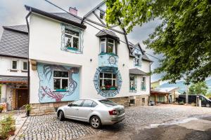 a house with a car parked in front of it at art-house 1 apartment with terrace in Děčín