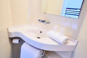 a bathroom with a white sink and a mirror at Premiere Classe Tours Sud - Joue Les Tours in Joue-les-Tours +23 photos