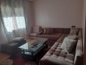 a living room with a couch and a coffee table at Beautiful apartment in Agadir