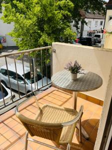 a table and two chairs and a table on a balcony at City Appartement Kirchheim in Kirchheim unter Teck