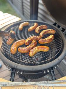 a bunch of sausages cooking on a grill at D&A Apartamentai in Palanga