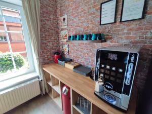 a room with a wooden counter with a brick wall at Hotel & Gasthaus Zum Domkreuger in Walsrode