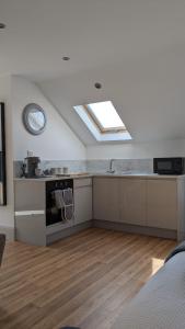 a large kitchen with a skylight in a room at Brodleys' Hill Studio 286d in Ballymena