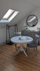 a room with a table and two chairs and a mirror at Brodleys' Hill Studio 286d in Ballymena