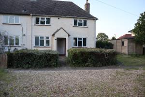 a white house with a driveway in front of it at 3 Bed Semi sleeps 7 in Oxford in Oxford