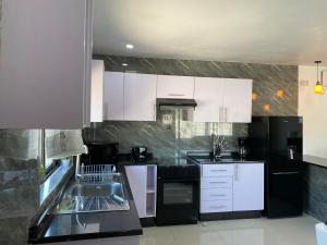 A kitchen or kitchenette at Swiss Luxury Apartments
