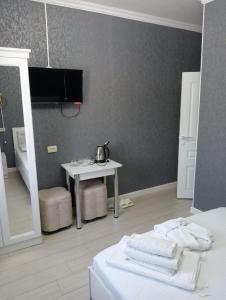 um quarto com uma cama e uma mesa com toalhas em Keruen Deluxe em Taraz