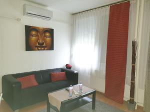 a living room with a couch and a table at Goldapartman Salgótarján in Salgótarján