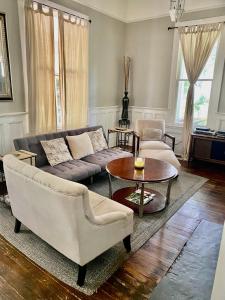 a living room with a couch and a table at Classic/Modern Downtown Home in Valdosta