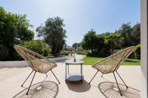 two chairs and a table on a patio at The Lake Apartments in Kommeno