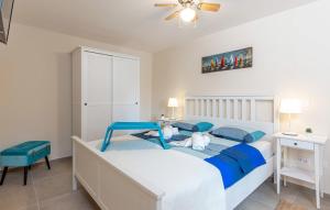 a bedroom with a large bed with blue pillows at NINA ROSE boutique villa in Lovran