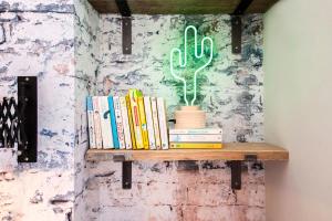 een plank met boeken en een cactus erop bij higgihaus 7 Bed Sleeps up to 18 Big Groups Best Location in Bristol