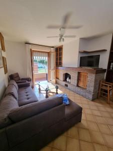 a living room with a couch and a fireplace at Casa Bortoli in Castiglione della Pescaia