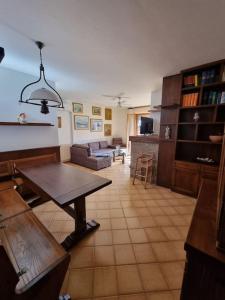 a living room with a table and a couch at Casa Bortoli in Castiglione della Pescaia