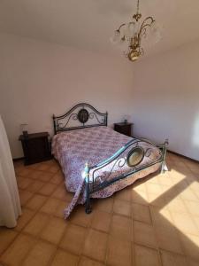 a bedroom with a bed and a light on the floor at Casa Bortoli in Castiglione della Pescaia