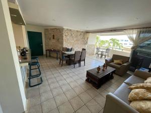 a living room with a couch and a table at Departamento en chipipe salinas in Salinas