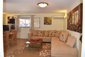 a living room with a couch and a table at Guest House Mary in Porto Heli