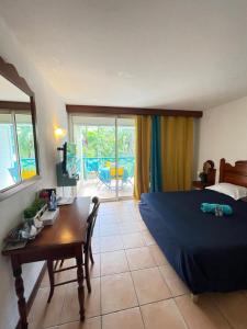 una camera da letto con un letto, una scrivania e un tavolo di Studio La «KAZ’ À COCO» Anse Caritan a Sainte-Anne