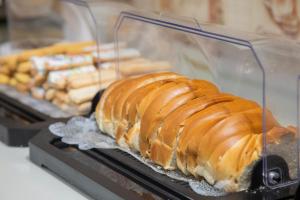 a croissant on a display case in a bakery at A1 hotel in Foz do Iguaçu