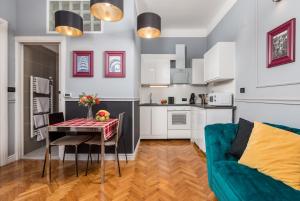 a kitchen and living room with a table and a couch at apartment Tiziano-Belveder with private garage in Rijeka
