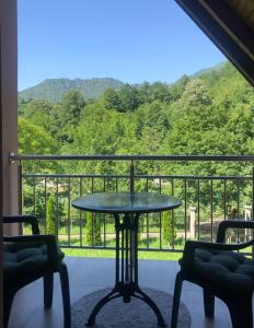 een tafel en stoelen op een balkon met uitzicht bij Villa Pjene in Konjic