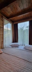 um quarto com 2 camas e uma janela em Shato Maxuntseti em K'veda Bzubzu