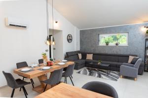 a living room with a table and a couch at Villa Ardanela in Labin