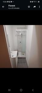 a small bathroom with a shower and a sink at Bel appartement avec Terasse Proche Gare in Cergy