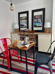 a dining room with a table and red chairs at SURF HOUSE DREAMERS COAST in Klaipėda