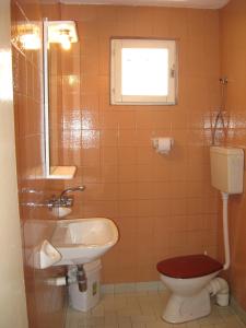 a bathroom with a toilet and a sink at Elefterova kashta in Arbanasi +20 photos