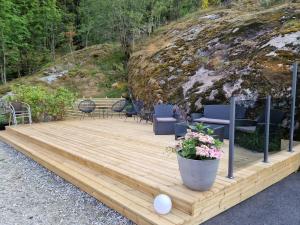 a wooden deck with chairs and a table at Kvamsdal Pensjonat 1 in Eidfjord