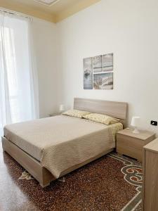1 dormitorio blanco con 1 cama y una pintura en la pared en Kello's House, en Savona