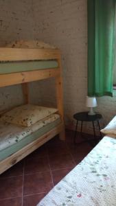 a bedroom with two bunk beds and a table at Niezapominajka in Kletno