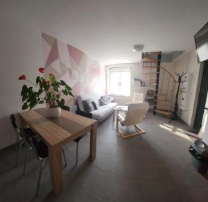 a living room with a table and a couch at la halte des trois rivieres in Plichancourt