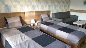 Posteľ alebo postele v izbe v ubytovaní Green Apartman Salgótarján