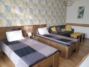 Posteľ alebo postele v izbe v ubytovaní Green Apartman Salgótarján