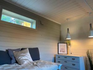 a bedroom with a bed and a window and a dresser at Martin Barstads veg 3b in Trondheim