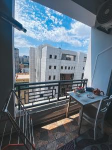 a balcony with a table and a view of a city at Originative style of the apartment in Baku
