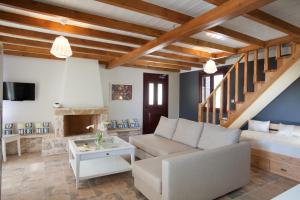 a living room with a couch and a table at Ivi Villa in Sivota
