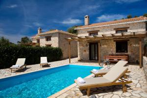an external view of a villa with a swimming pool at Ivi Villa in Sivota