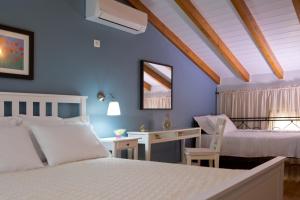 a bedroom with two beds and a desk at Ivi Villa in Sivota +24 photos