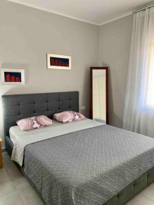 a bedroom with a large bed with pink pillows at Luxury spacious apartment in the heart of the city in Rhodes Town